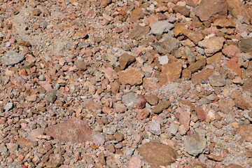 Bright red rock of earth, stones. The texture of the earth.