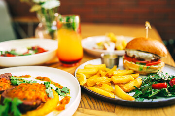 a full table of food and soft drinks at the summer cafe. second courses with refreshing drinks in a coffee shop