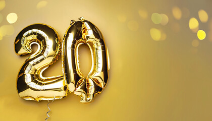 Banner with number 20 golden balloons with copy space. Twenty years anniversary celebration concept on a yellow background with shiny bokeh.