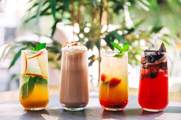 soft drinks on the summer coffee shop. refreshing sweet drinks with ice on the cafe table. summer cold drinks of different taste