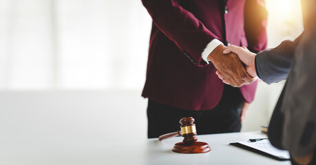 Portrait of lawyer in law office hand shake giving advice and advice on lawsuit consulting concept