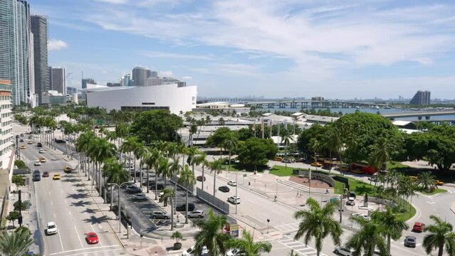 Drone view of busy streets of Miami stretching from Downtown to Bayfront Park, showcasing iconic Kaseya Center and vibrant Biscayne Blvd. Cosmopolitan atmosphere of Miami Beach