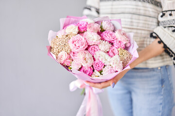 Beautiful bouquet of mixed flowers in woman hand. Floral shop concept . Beautiful fresh cut bouquet. Flowers delivery