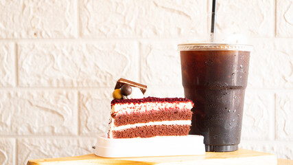 Iced Americano coffee and fresh milk cake served on the table.