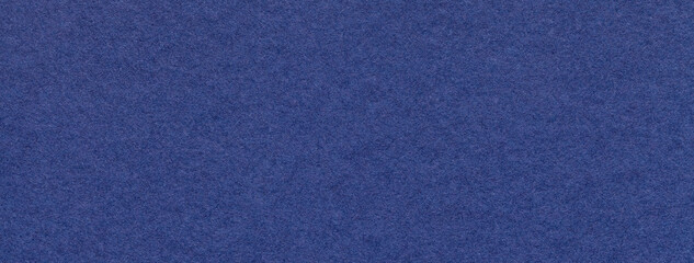 Texture of craft navy blue paper background colors, macro. Structure of vintage kraft denim cardboard.