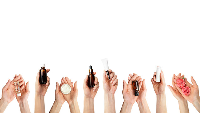 Female caucasian hands hold beauty cosmetisc products on white background