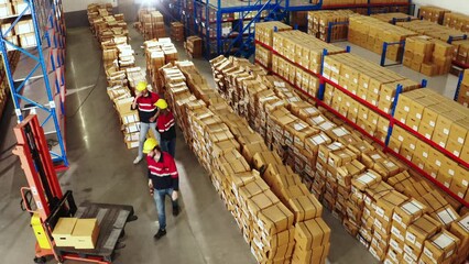 From high above, a drone captures an expansive view of a bustling logistics center, where products and goods are delivered and distributed with precision and efficiency.