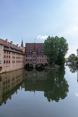 Famous view of Glasses of Nuremberg Heilig-Geist-Spital in old city Nuremberg in Franconia, Bavaria, Germany. Historical center of Nurnberg in Pegnitz River. High quality photo
