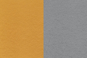 Fototapeta premium Texture of craft dark yellow and gray paper background, half two colors, macro. Vintage ocher cardboard.