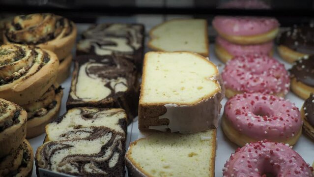 chocolate donuts and cake display for sale at local store 