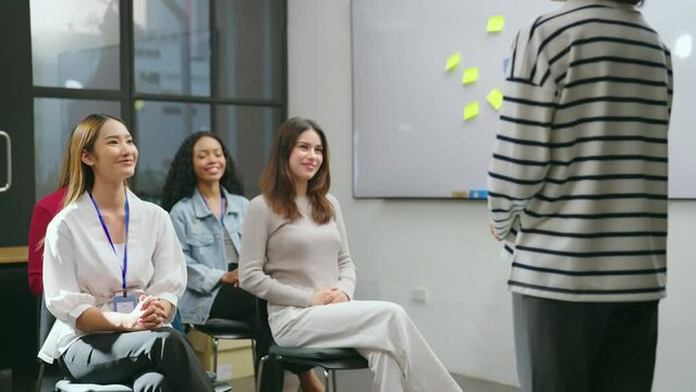 The female businesswoman is seen conversing with her team in a contemporary office setting, passionately describing her work at meeting room.