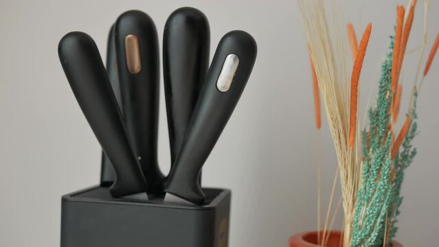 Set of kitchen knives in a box .