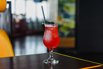 Summer Cocktail Sex on the Beach.Fresh red alcoholic cocktail with berries on bar counter, space for text.