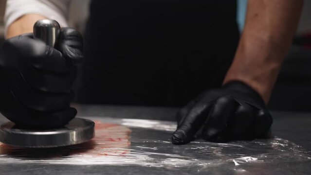 Hand of a Cook uses the meat tenderizer to prepare the prawns