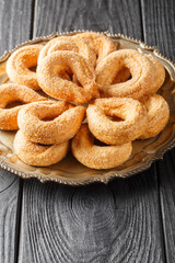 Sweet italian cookies Torcetti Piemontesi closeup on the plate on the table. Vertical