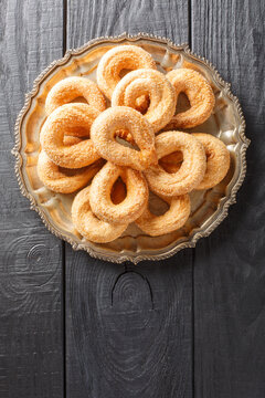Sweet italian cookies Torcetti Piemontesi closeup on the plate on the table. Vertical top view from above