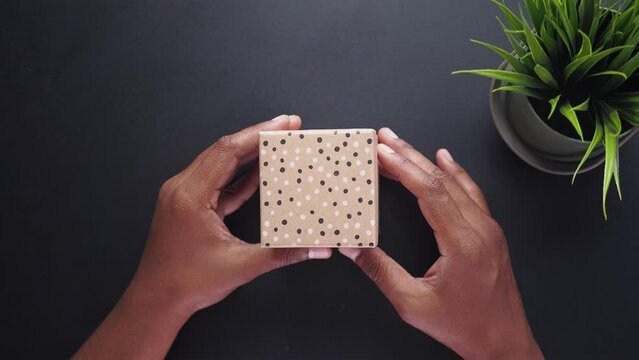 top view of person open a empty small gift box 