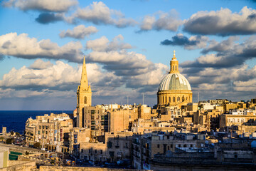 City view of Valletta just before sunset. Historical buildings and old town with sea and clouds