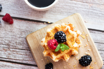 Belgian waffles with berries. Morning. On a wooden background