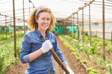 Smiling female farmer working at farm