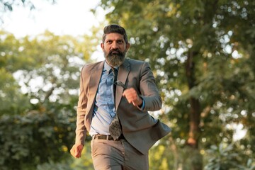 Naklejka na ściany i meble Indian corporate man running at park.