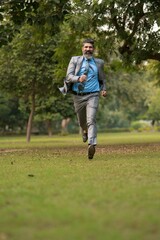 Indian corporate man running at park.