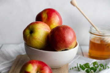 honey with apples and honey. on a white table