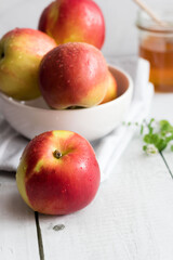 honey with apples and honey. on a white table