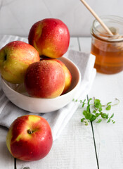 honey with apples and honey. on a white table