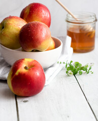 honey with apples and honey. on a white table