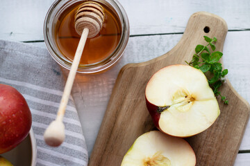 honey with apples and honey. on a white table