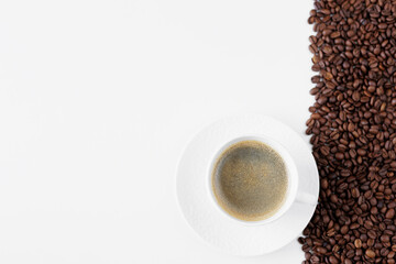 Top view of coffee mug and coffee beans on table