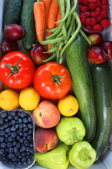 Wooden crate full of healthy colorful seasonal fruit and vegetable. Top view.