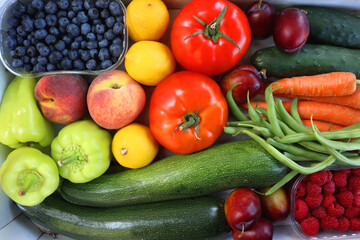 Wooden crate full of healthy colorful seasonal fruit and vegetable. Top view.