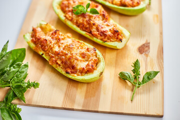 Stuffed zucchini on white background, baked loaded zucchini boats, Top view, Homemade.
