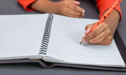 left-handed and his hand is visible as he writes