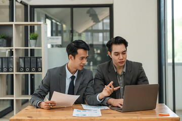 Asian business adviser meeting to analyze and discuss the situation on the financial report in the meeting room. Investment Consultant, Financial Consultant, Financial advisor and accounting concept