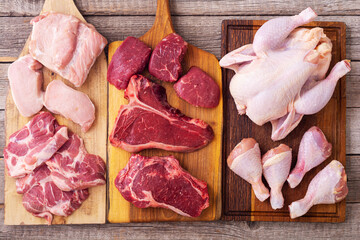 Assortment of raw meat chicken , beef and pork .