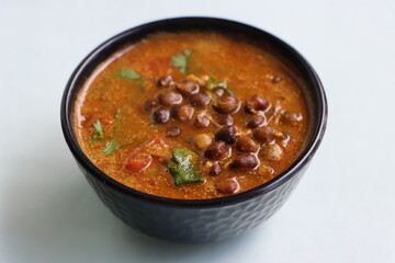 Kalya Vatanyachi Usal, kala vatana sambar or aamti, curry made with dried black peas in gravy with...