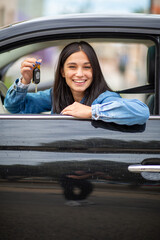 smiling young woman with keys in hand