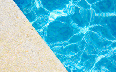 The edge of the pool on a sunny day at the hotel. Top view, copy space