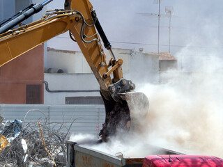 Excavator Bucket Load Garbage into Truck