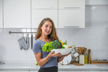 A caucasian woman holding a bowl of mix vegetables. Vegetarian or vegan food healthy lifestyle concept.
