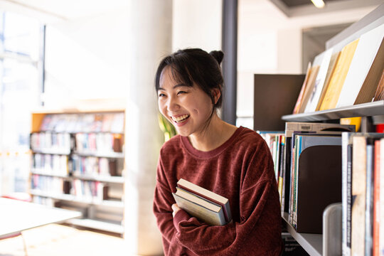 Young adult asian female student at the library