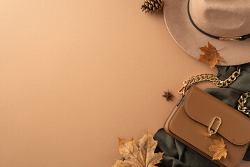Classic female outfit with autumn hues. Top view of felt hat, grey scarf, beige purse, vibrant maple leaves, anise, and pine cone arranged on a beige background with room for text or advertising
