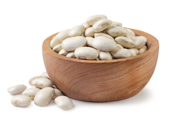 White beans in a wooden plate and scattered. Isolated