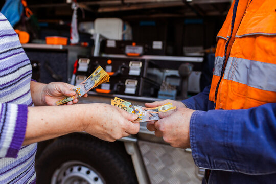 Person paying in cash for professional tradesman services