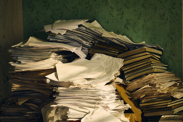 A lot of various office documents (waybills, passes, accounting books) are piled up in some...