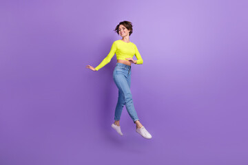Fototapeta na wymiar Full size portrait of pretty peaceful carefree slender girl jumping running isolated on purple color background