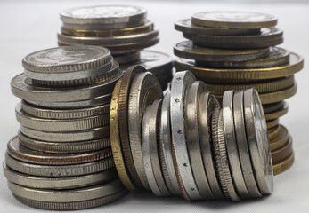 Silver and gold coins from different countries and times - standing coins and coin towers, macro